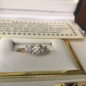Three stone diamond ring in gold band
